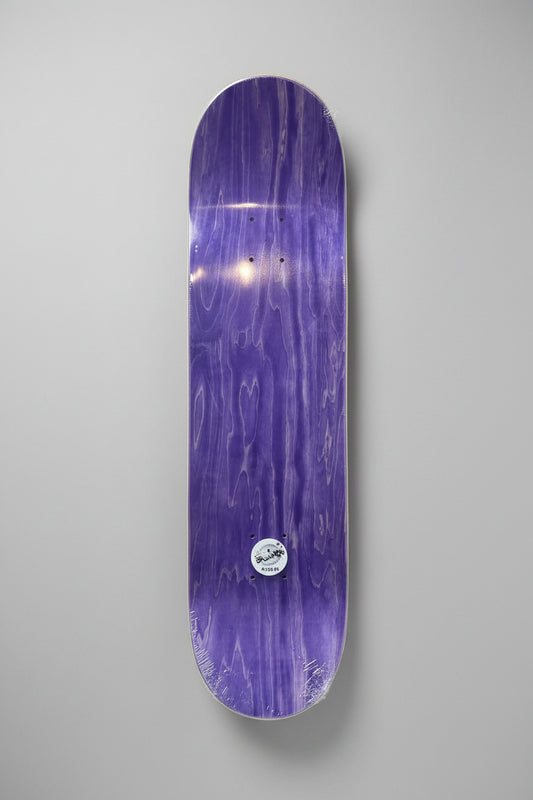 A purple skateboard deck with a glossy woodgrain finish and a small circular sticker near the bottom, shown against a neutral gray background.