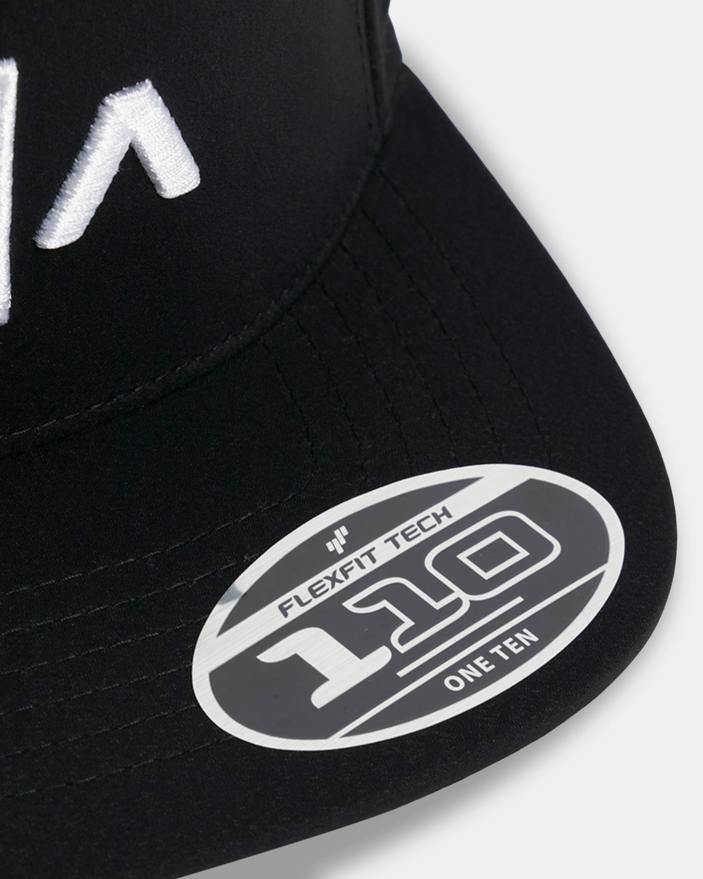 Black cap with Flexfit Tech logo on a white background