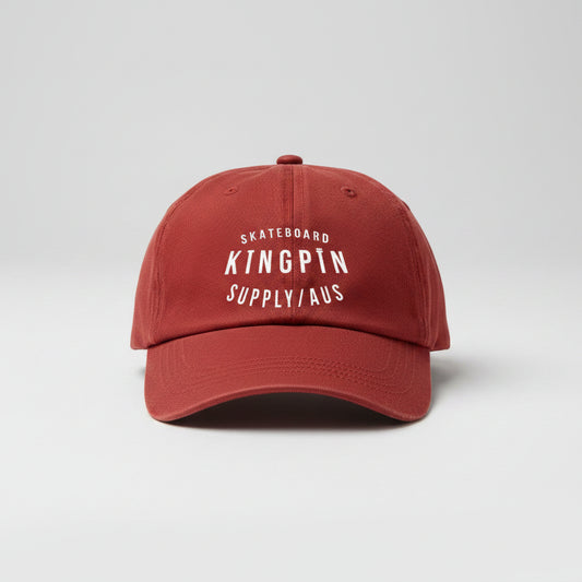 A red snapback hat with 'Kingpin Skate Supply' text printed on the front.