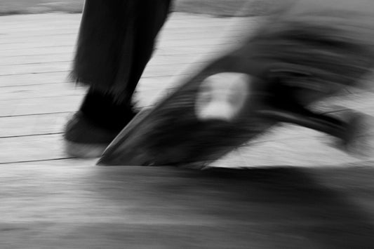 person in black pants walking on snow covered ground