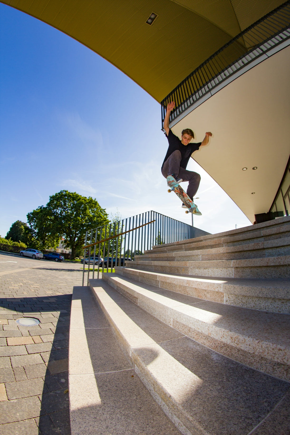 A man riding a skateboard down the side of a set of stairs