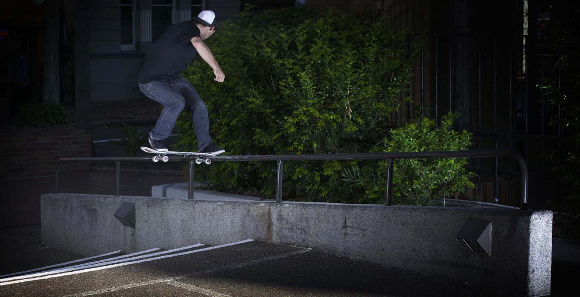 Team Rider Sam Giles with a solid front side nose slide on a hefty rail in Wollongong CBD
