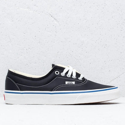 A single Vans sneaker in navy blue canvas with white laces, a thick white platform sole, and a thin blue stripe, shown against a light gray textured background.