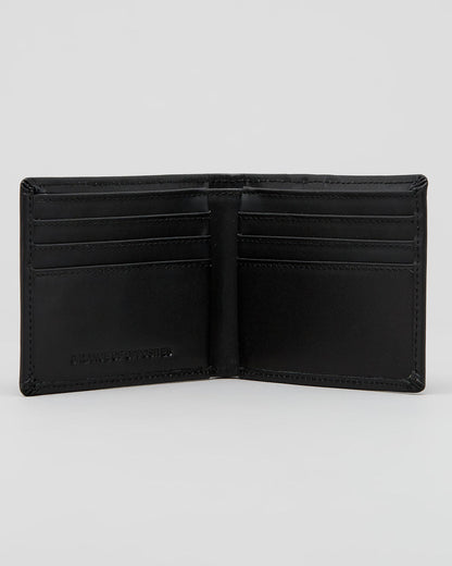 An open black leather bi-fold wallet with multiple card slots and a debossed logo on the lower left interior, shown against a light gray background. RVCA
