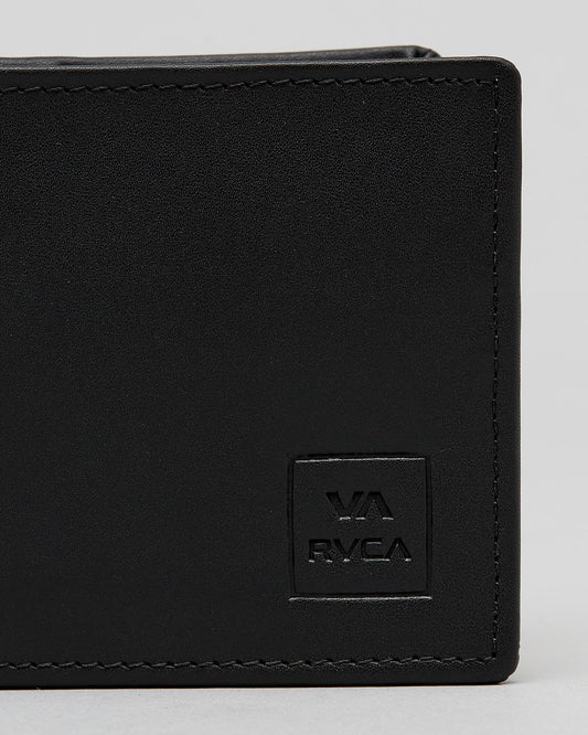 Close-up of a black leather bi-fold wallet showing the corner, black stitching, and an embossed square logo patch with 'VA RVCA' on a light gray background. cedar bifold