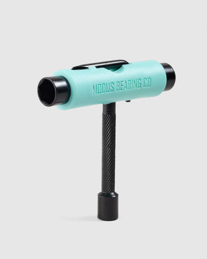 A mint green and black T-handle tool with 'MDDUS BEARING CO' embossed on the side, standing vertically against a light gray background.