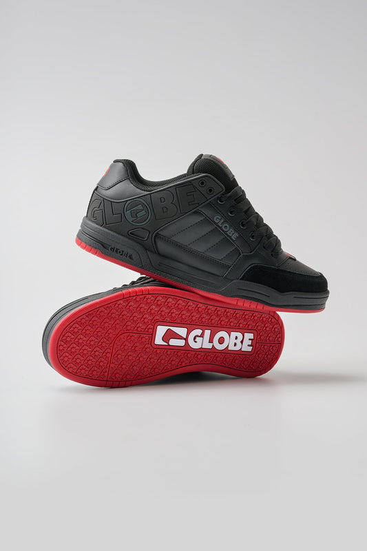 Black and red sneaker with 'Globe' branding on a light gray background