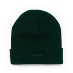 A dark forest green knit beanie with a folded cuff, featuring the word 'modus.' embroidered in matching green on the front cuff, set against a plain white background.