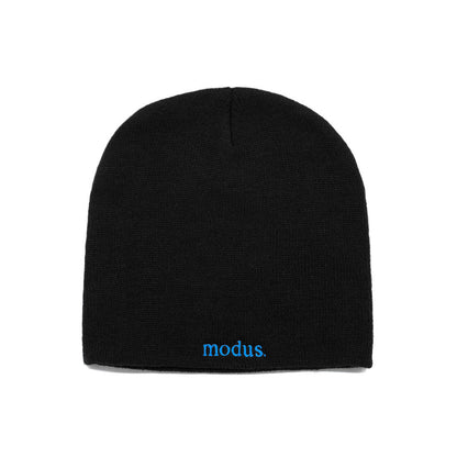 A black knit beanie hat with the word 'modus.' embroidered in bright blue on the front cuff, shown against a plain white background.