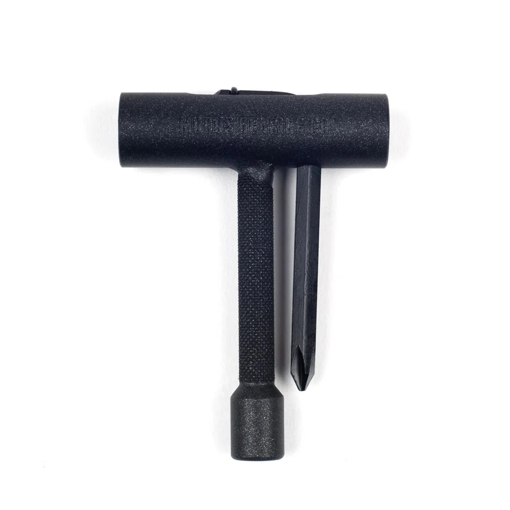 A black plastic T-shaped tool with a textured handle and a flat blade, shown on a plain white background.