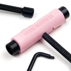 Pink tool with black ends on a white background