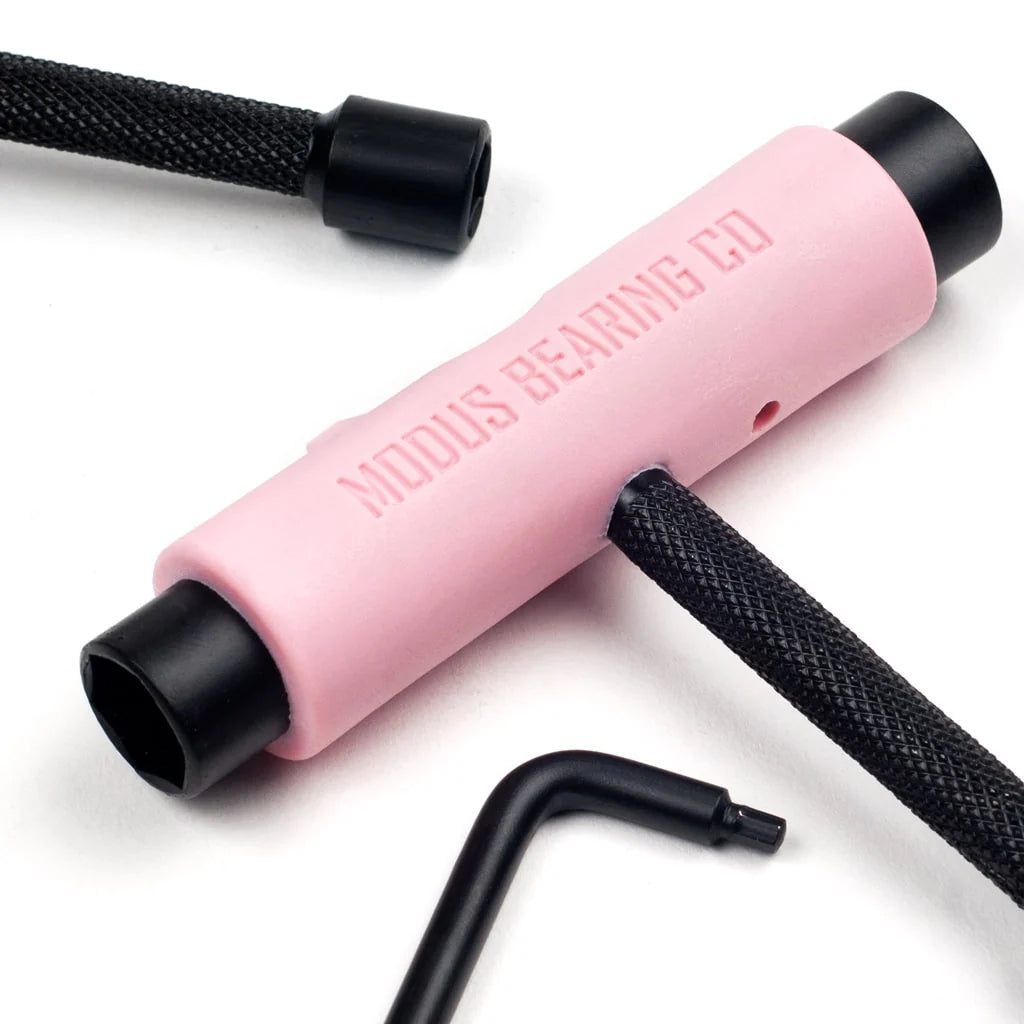 Pink tool with black ends on a white background