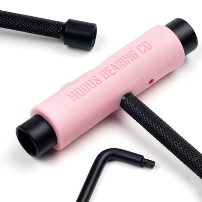 Pink tool with black ends on a white background