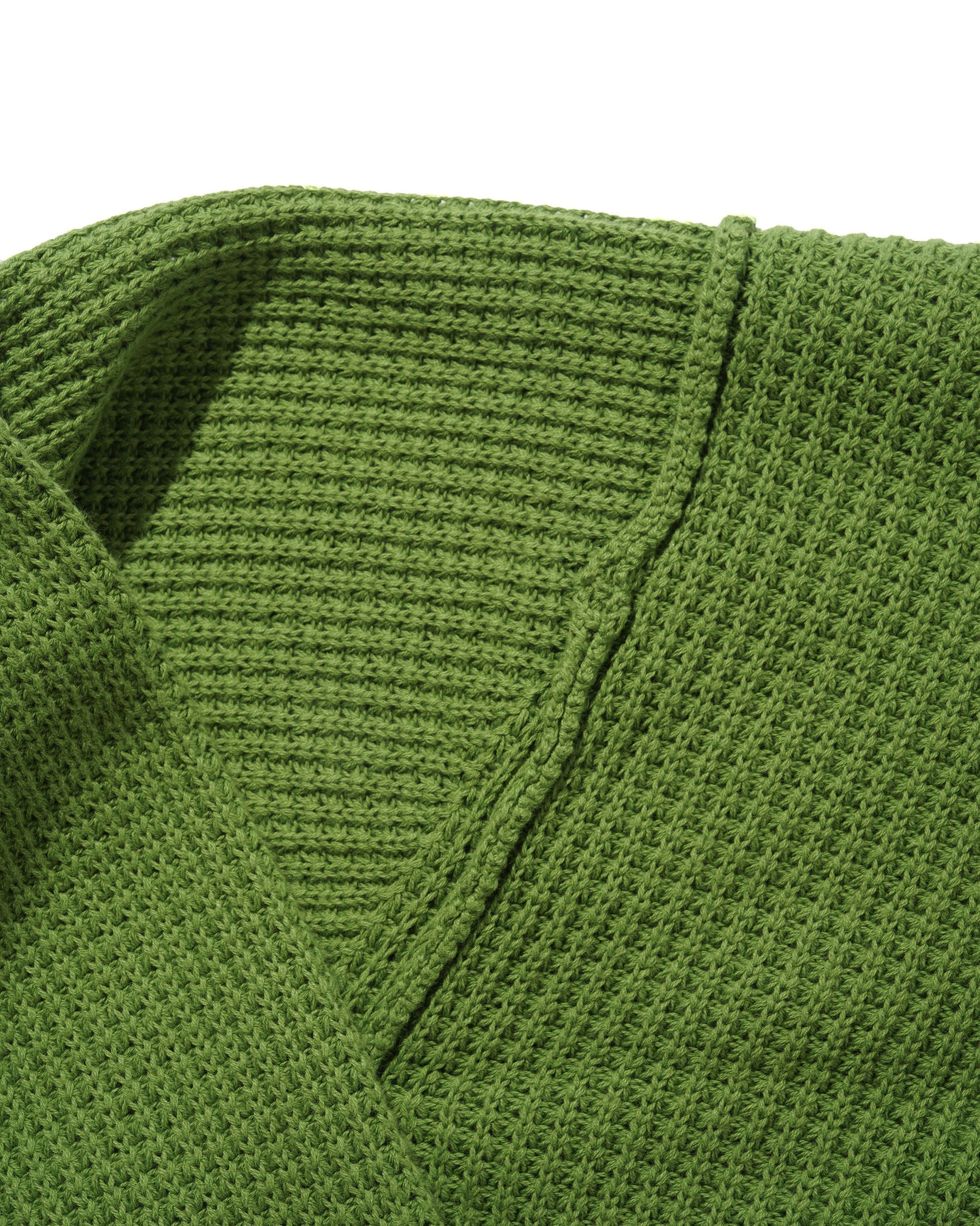 Close-up of a green knitted sweater with a V-neck