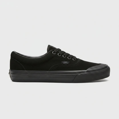 A black Vans era sneaker with a thick black sole, shown from the side against a light concrete floor.