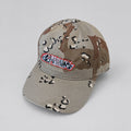 A desert camouflage baseball cap with a graffiti logo.