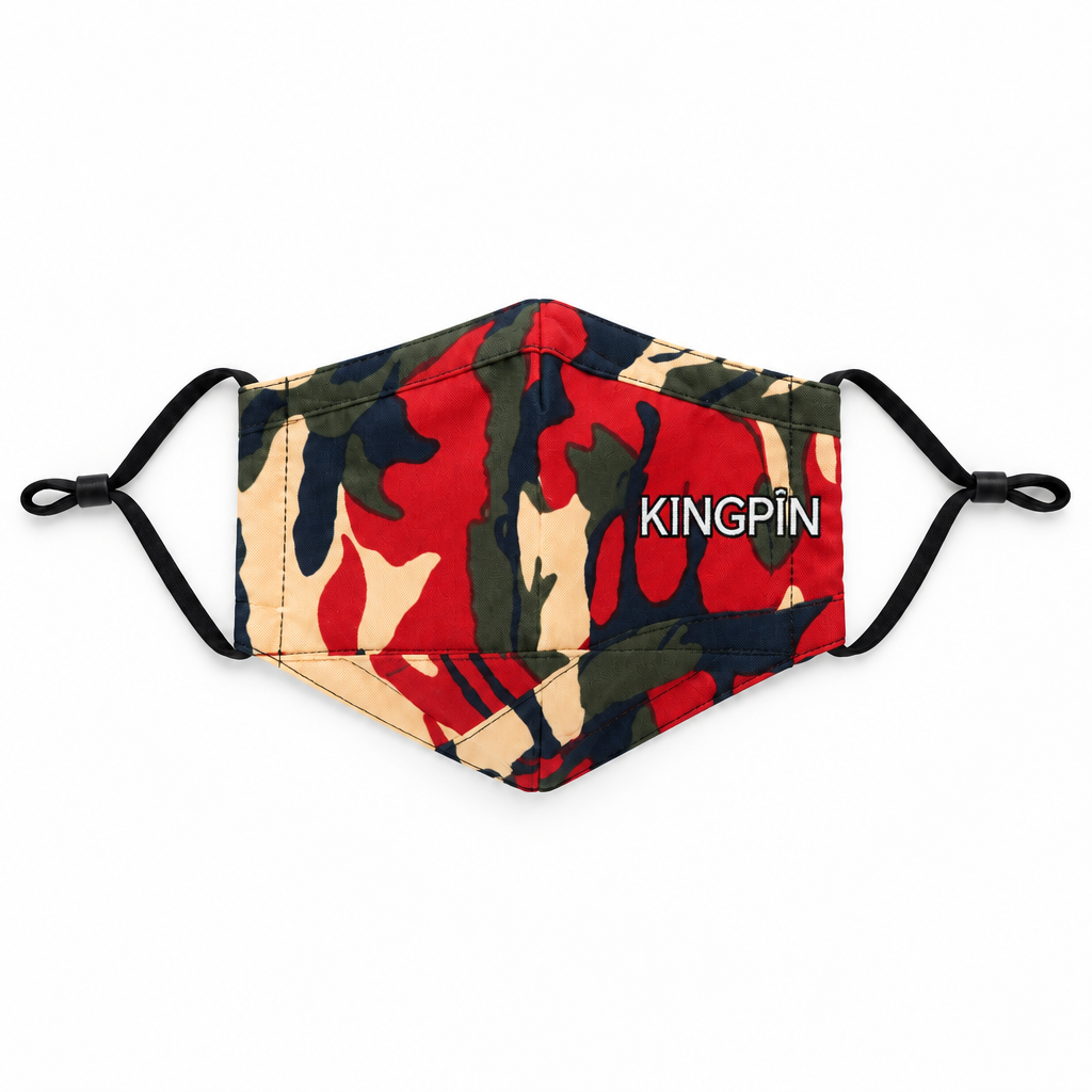 A fabric face mask with a red, beige, and dark green camouflage pattern, featuring the text 'KINGPIN' printed in white across the right side. The mask has black elastic ear loops and is photographed flat against a solid white background.