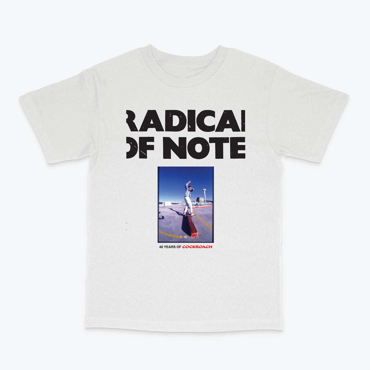 A white short-sleeve crewneck t-shirt featuring a black graphic print that reads 'RADICAL OF NOTE' above a square photo of a person skateboarding on a ramp, with '40 YEARS OF CORKINBOYZ' printed below.