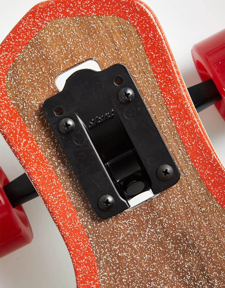 Close-up of red speckled grip tape texture and black Slush brand drop-through truck hardware mounted on dark wood deck