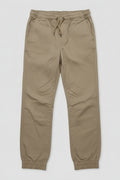 A pair of kingpin slim fit khaki chino pants with an elastic waist and drawstring, and elastic cuff ankles lay flat.