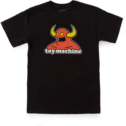 A toy machine monster black short-sleeve crewneck t-shirt featuring a graphic of a red horned monster with yellow horns and the text 'toy machine' printed below it, displayed flat against a white background.