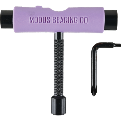 A T-shaped bearing tool with a lavender purple handle and black textured shaft, shown alongside a small black hex key on a plain white background. The handle is embossed with the brand name 'MODUS BEARING CO'.