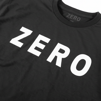 Close-up of a black crewneck t-shirt featuring the word 'ZERO' printed across the chest in large, bold white sans-serif letters. The brand name 'ZERO' is also visible inside the collar.